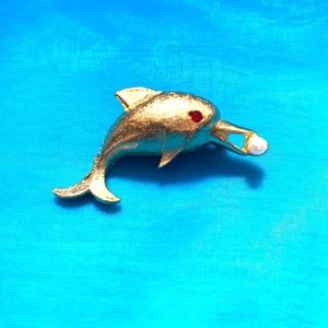 Adorable Gold-tone Dolphin Pin with pearl in his mouth and red rhinestone eye.
